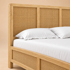 Adelaide Solid Wood Rattan Bed — warm beige studio detail