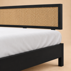 California Black Rattan Bed - Mango Wood — warm beige studio detail